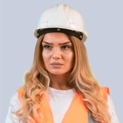 A woman with long blonde hair, wearing a white construction helmet and an orange safety vest, stands against a plain gray background. She exudes focus and seriousness, ready to tackle any security fencing project with a clear view of the task ahead.